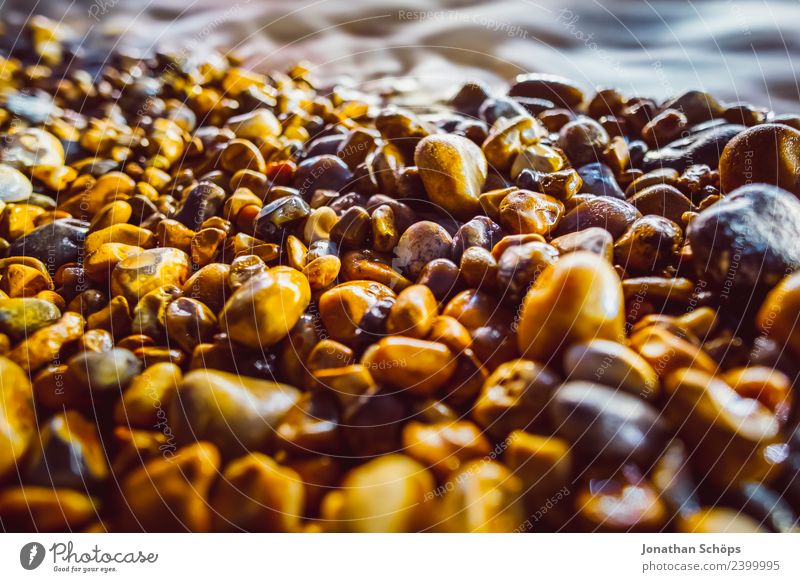 lighted stone beach Water Sun Coast Beach Pebble beach Brighton Great Britain Europe Glittering Cold Round Relaxation Moody Hard Smoothness Wet Colour photo