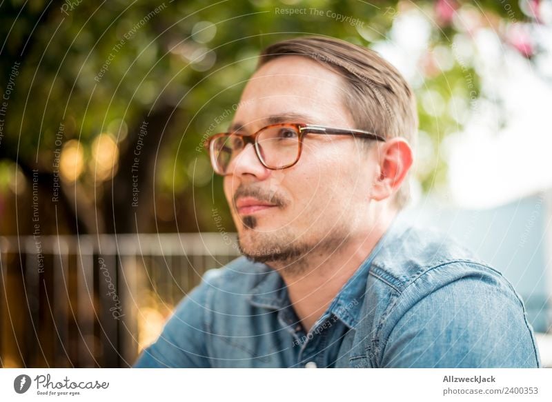 Portrait of a young man with glasses Day Exterior shot Portrait photograph 1 Person Young man Person wearing glasses Eyeglasses Facial hair Moustache