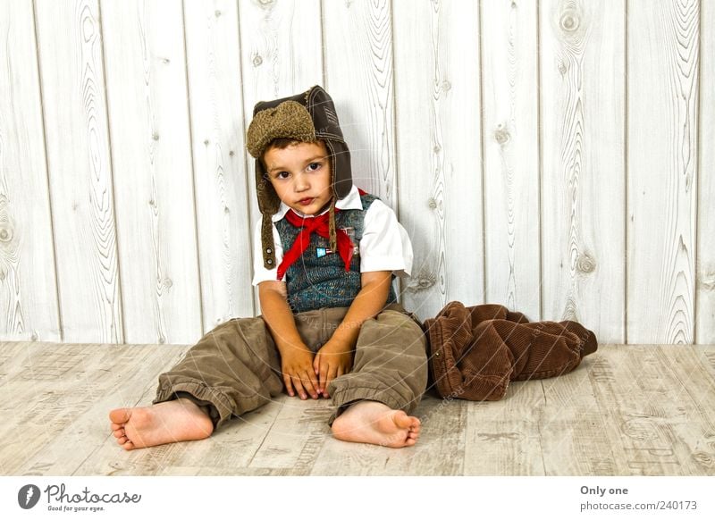 boy relex Sweater Jacket Cap Emotions Cool (slang) Optimism Warm-heartedness Boredom Relaxation Freedom Colour photo Studio shot Flash photo Contrast