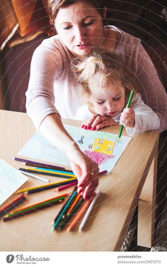 Mom with little daughter drawing the colorful pictures Lifestyle Joy Happy Handcrafts Table Kindergarten Child School Human being Girl Woman Adults Parents