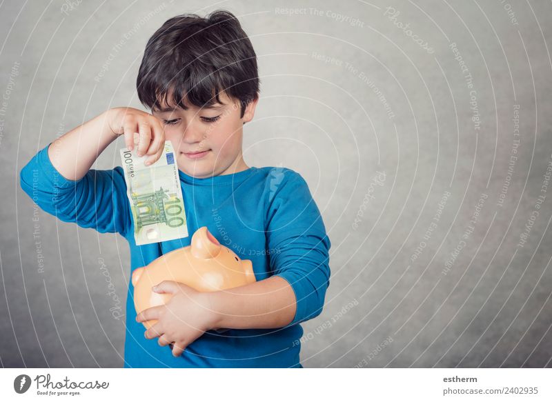 child saving money in a piggy bank on gray background Lifestyle Shopping Luxury Joy Happy Money Human being Masculine Child Toddler Infancy 1 8 - 13 years