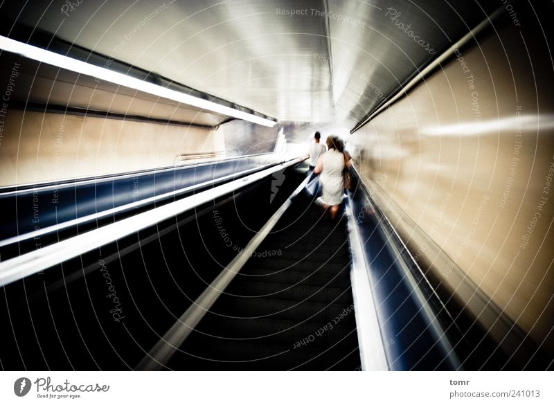 Metro station escalator Capital city Train station Tunnel Transport Means of transport Public transit Rail transport Underground Esthetic Speed Gold Gray Black