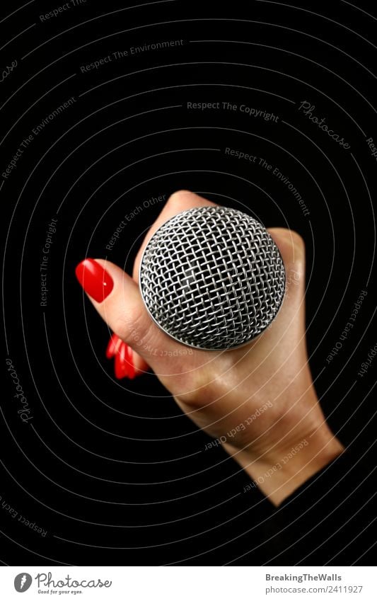 Woman hand holding microphone on black background Human being Young woman Youth (Young adults) Adults Hand 1 Music Concert Stage Singer Musician Record Media