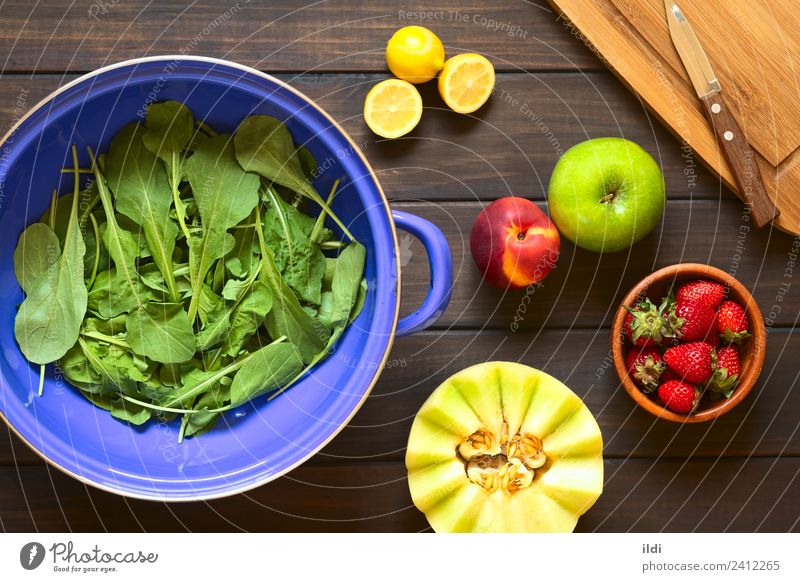 Rucola and Fruits Vegetable Fresh Salad Rocket lettuce rucoli rugula colewort eruca sativa food Ingredients healthy cooking strainer Lemon citrus Strawberry