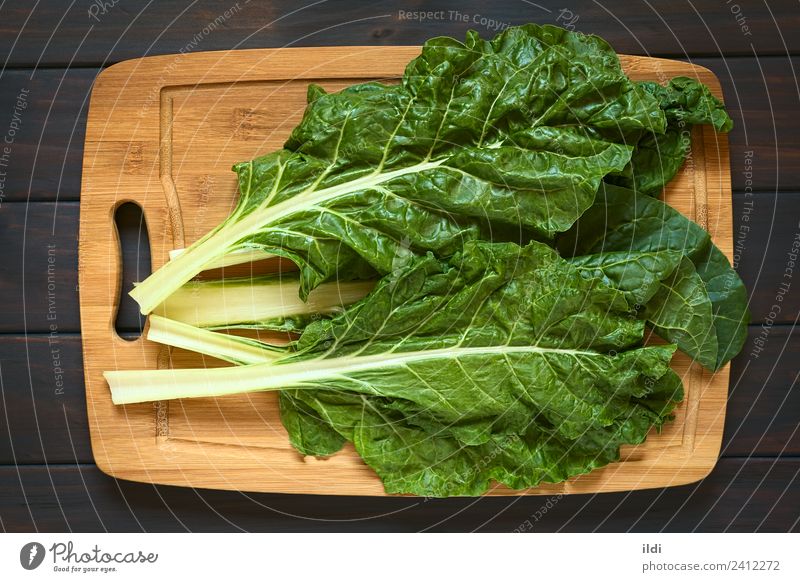 Raw Chard Leaves Vegetable Fresh Healthy Green chard Mangold mangel Beta vulgaris Verdant Stalk food Ingredients Mediterranean cooking wood board overhead