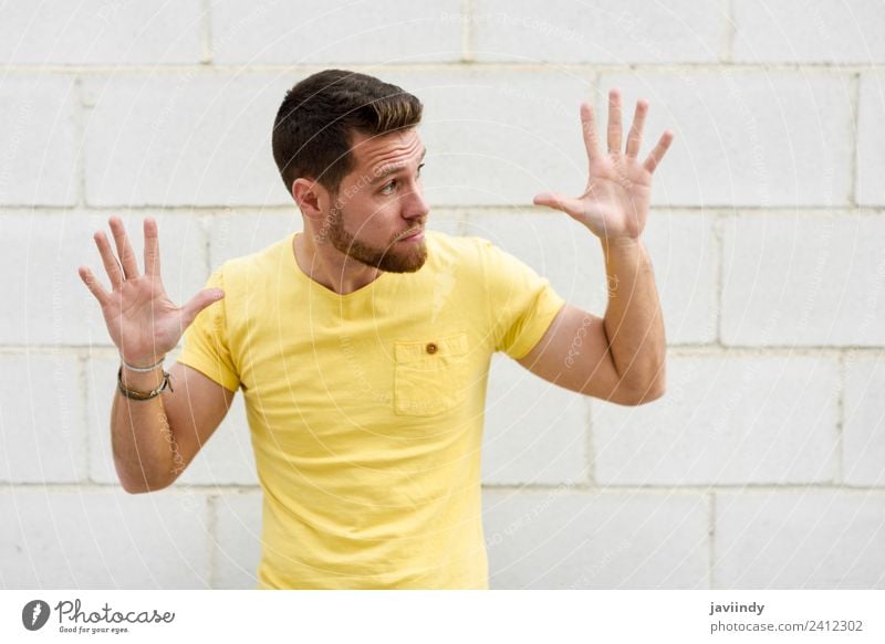 Young man on brick wall with open hands looking at rightside Lifestyle Style Happy Human being Masculine Youth (Young adults) Man Adults Hand 1 18 - 30 years