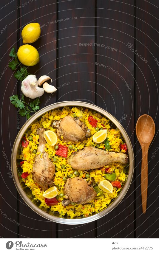 Spanish Chicken Paella Meat Vegetable Fresh paella poultry Thigh Rice Dish Meal food Valencian Mediterranean cooking pepper Peas legume Pulse Lemon Rustic