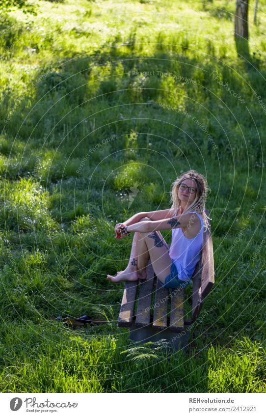 Woman sitting on a bench in the green in summer Human being Feminine Young woman Youth (Young adults) Sit Relaxation Lifestyle Leisure and hobbies Environment