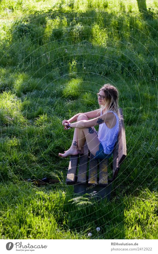 Jule Young woman with dreads is sitting on a bench in the green. Lifestyle Style Leisure and hobbies Bench Human being Feminine Youth (Young adults) 1