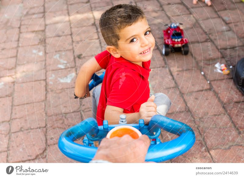 Father's hand pushing a child's tricycle Joy Playing Summer Garden Sports Child Boy (child) Parents Adults Family & Relations Hand Park Smiling Perspective