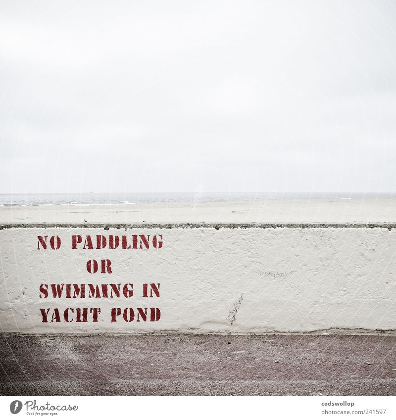 grey summer day Wall (barrier) Wall (building) Characters Signs and labeling Signage Warning sign Bans Typography English North Sea coast England Beach Horizon