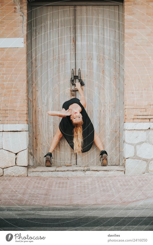 Blonde woman with black dress dancing hanging from a door. Elegant Style Beautiful Entertainment Dance Fitness Sports Training Human being Young woman