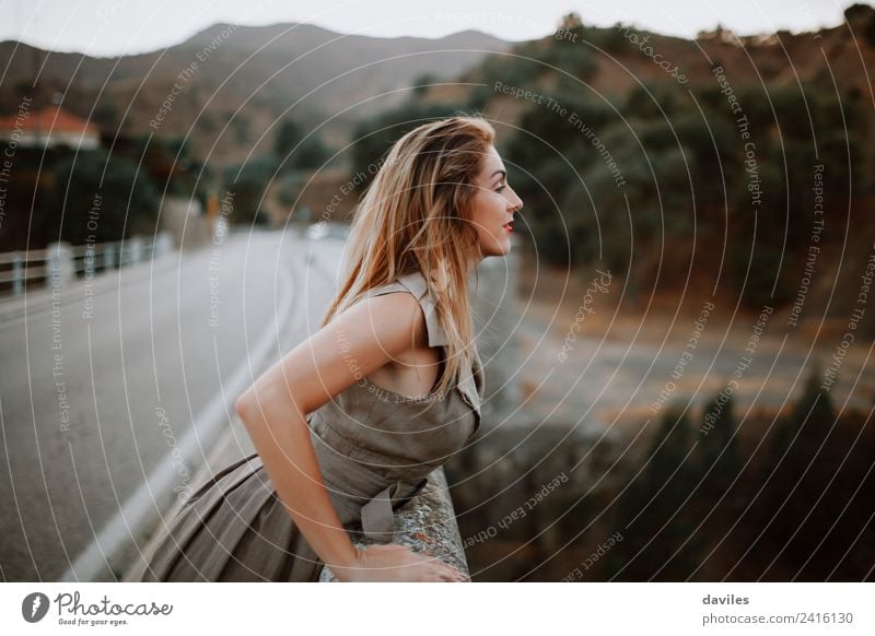 Cute blonde woman peeking on a bridge at the road. Lifestyle Beautiful Vacation & Travel Tourism Human being Feminine Woman Adults 1 18 - 30 years