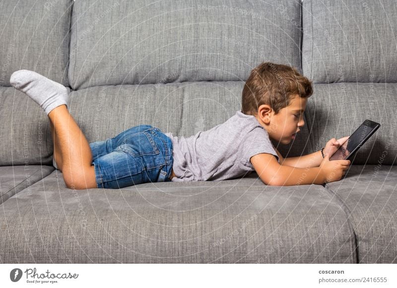 Little boy using a tablet Happy Leisure and hobbies Playing Sofa Child School Computer Notebook Screen Technology Internet Baby Toddler Boy (child) Infancy