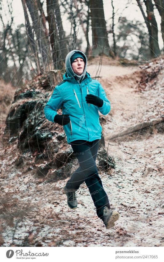 Young man running outdoors during workout in a forest Lifestyle Relaxation Leisure and hobbies Winter Sports Fitness Sports Training Jogging Human being