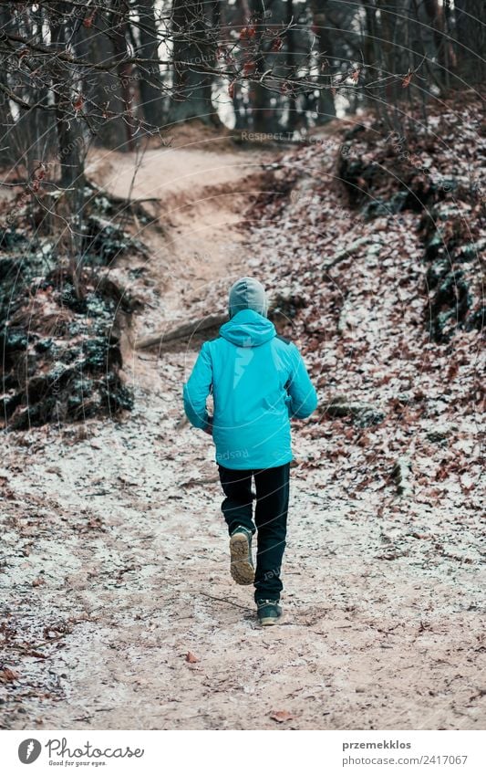 Young man running outdoors during workout in a forest Lifestyle Relaxation Leisure and hobbies Winter Sports Fitness Sports Training Jogging Human being