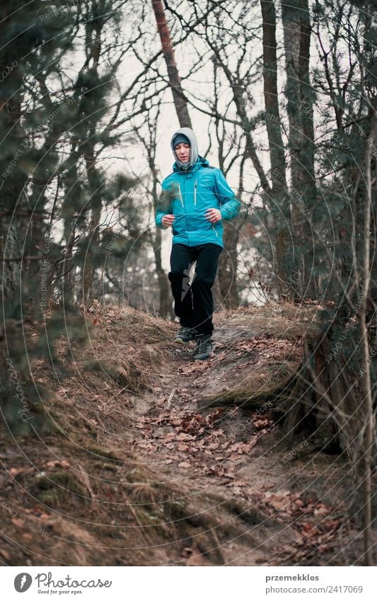 Young man running outdoors during workout in a forest Lifestyle Relaxation Leisure and hobbies Winter Sports Fitness Sports Training Jogging Human being