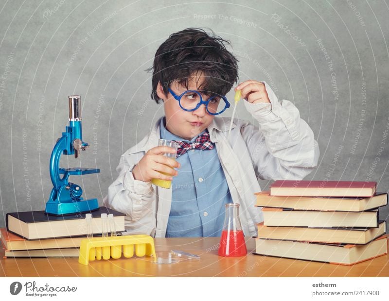 boy is making science experiments in a laboratory Lifestyle Education Science & Research Child Study Schoolchild Laboratory Human being Masculine Toddler