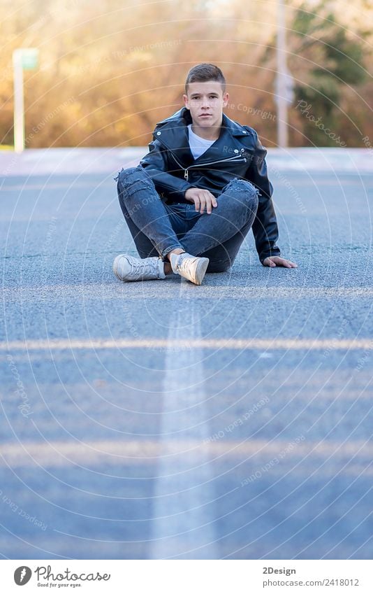 Stylish smiling teenager sitting on the road Lifestyle Joy Happy Schoolchild Academic studies PDA Human being Masculine Boy (child) Young man