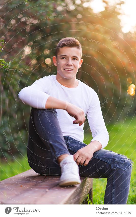 Stylish teenager sitting on a wooden bench Lifestyle Happy Schoolchild Academic studies PDA Human being Masculine Boy (child) Young man Youth (Young adults) Man