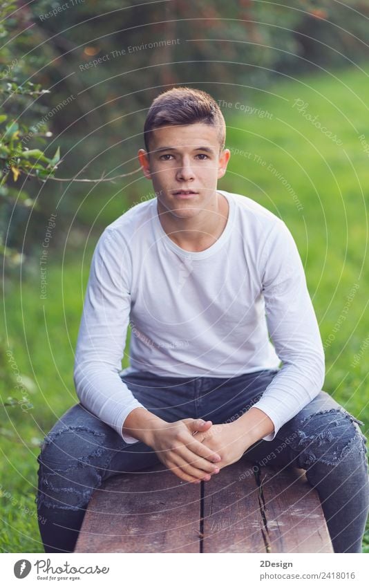 Stylish teenager sitting on a wooden bench on a city park Lifestyle Happy Schoolchild Academic studies PDA Human being Masculine Boy (child) Young man