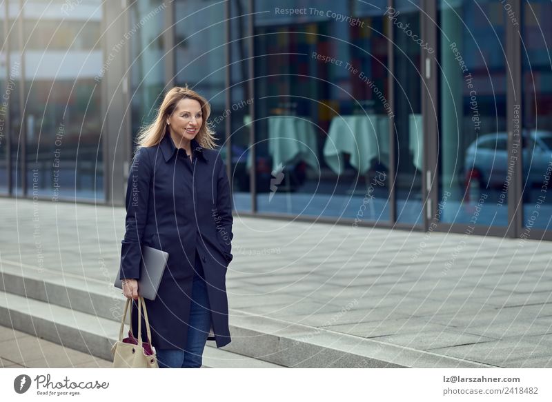 Attractive blond woman leaving her workplace Happy Face Workplace Business Telephone Computer Notebook Technology Woman Adults 1 Human being 45 - 60 years