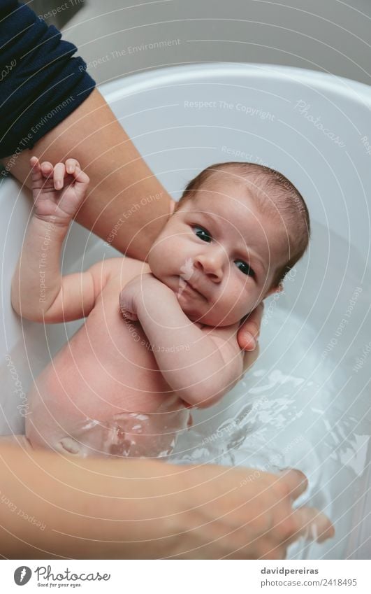 Newborn in the bathtub held by her mother Lifestyle Beautiful Calm Bathtub Bathroom Child Human being Baby Woman Adults Mother Family & Relations Hand Authentic