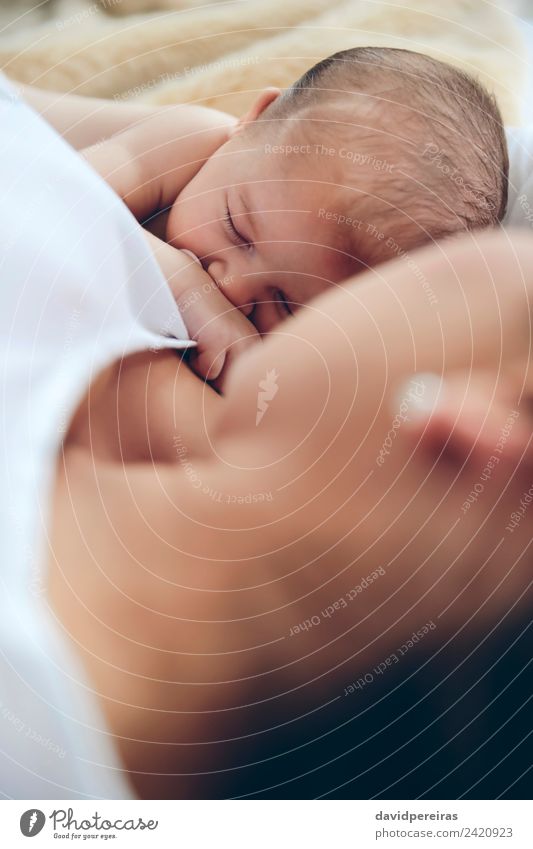 Newborn lying on the bed with her mother Lifestyle Beautiful Child Human being Baby Woman Adults Mother Family & Relations Love Sleep Embrace Authentic Together