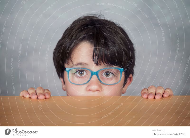 boy with glasses on a wooden table Lifestyle Education Human being Masculine Child Toddler Boy (child) Infancy 1 8 - 13 years Eyeglasses Observe Think Fitness