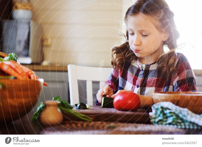 child girl helps mom to cook salad with knife Vegetable Lunch Dinner Lifestyle Joy Table Kitchen Child Mother Adults Family & Relations Growth Fresh Small Salad