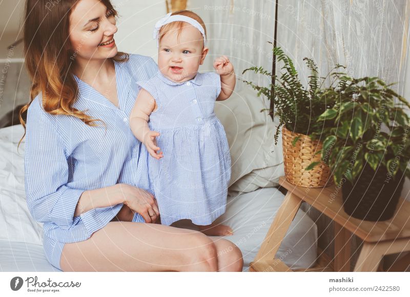 happy mother and 9 month old baby playing in bedroom Lifestyle Joy Playing Bedroom Baby Parents Adults Mother Family & Relations Infancy Hand Stripe Love