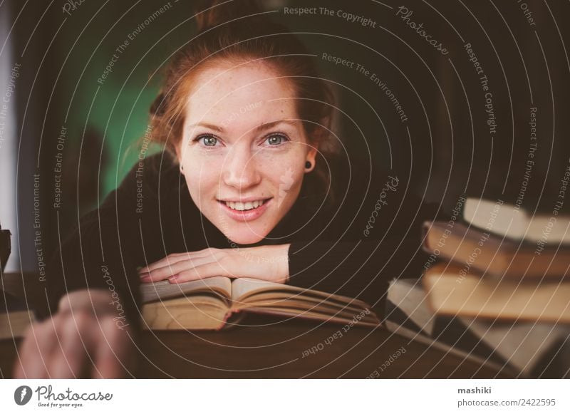 indoor portrait of redhead happy woman learning Lifestyle Relaxation Reading Table Academic studies Woman Adults Book Library Sweater Red-haired Study Dream