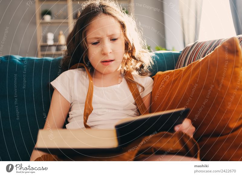 concentrated child girl reading interesting book at home Lifestyle Relaxation Reading Child Schoolchild Infancy Book Library Authentic Small Smart Home kid