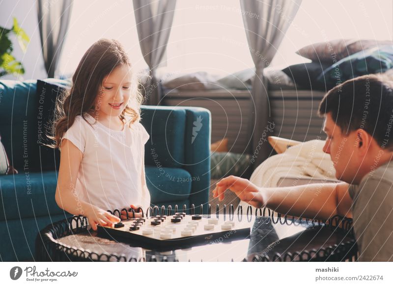 child girl playing checkers with her dad Lifestyle Joy Leisure and hobbies Playing Chess Success Child Parents Adults Father Family & Relations Toys Think