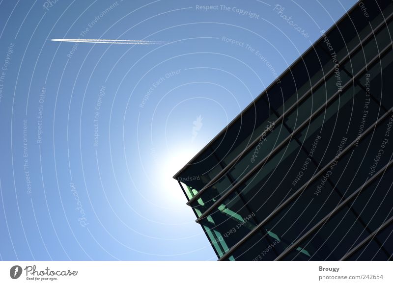 Corner of a modern building with sun and airplane Aviation Airplane Vapor trail Art Sky Cloudless sky Sun Sunlight Beautiful weather Friedrichshafen