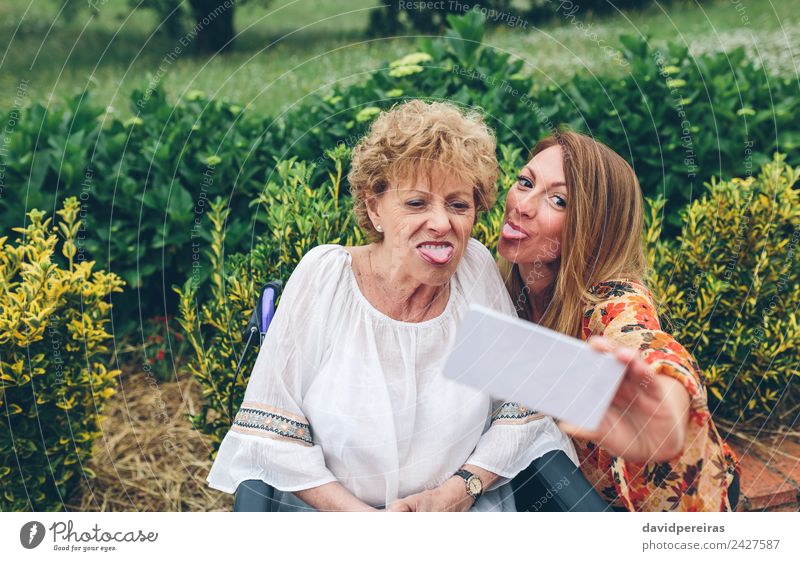 Woman taking selfie with older mother in wheelchair Lifestyle Joy Happy Health care Garden PDA Human being Adults Mother Grandmother Family & Relations Nature