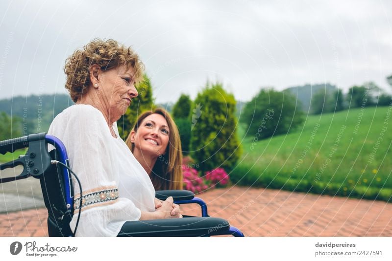 Senior dissatisfied woman in a wheelchair with her daughter Lifestyle Health care Relaxation Garden To talk Human being Woman Adults Mother Grandmother