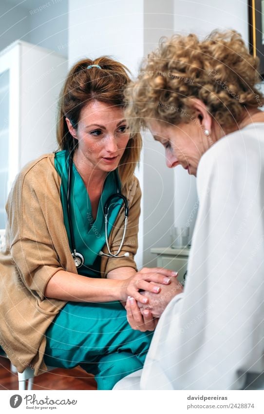 Female doctor giving encouragement to elderly patient Medical treatment Illness Medication Doctor Hospital To talk Human being Woman Adults Hand Old Advice