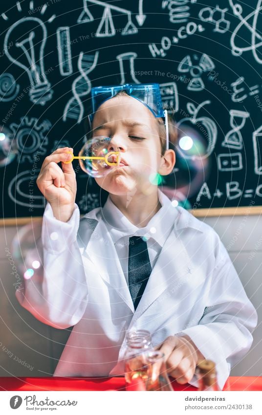 Kid doing soap bubbles against of drawn blackboard Bottle Joy Happy Playing Flat (apartment) Table Science & Research Child School Classroom Blackboard