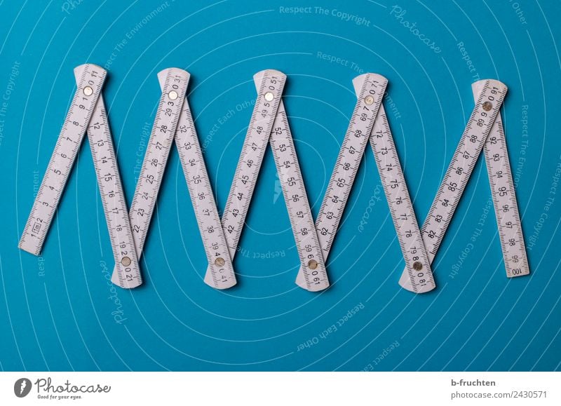 folding rule on blue background Craftsperson Workplace Craft (trade) Construction site Measuring instrument Work and employment Blue White Metre-stick