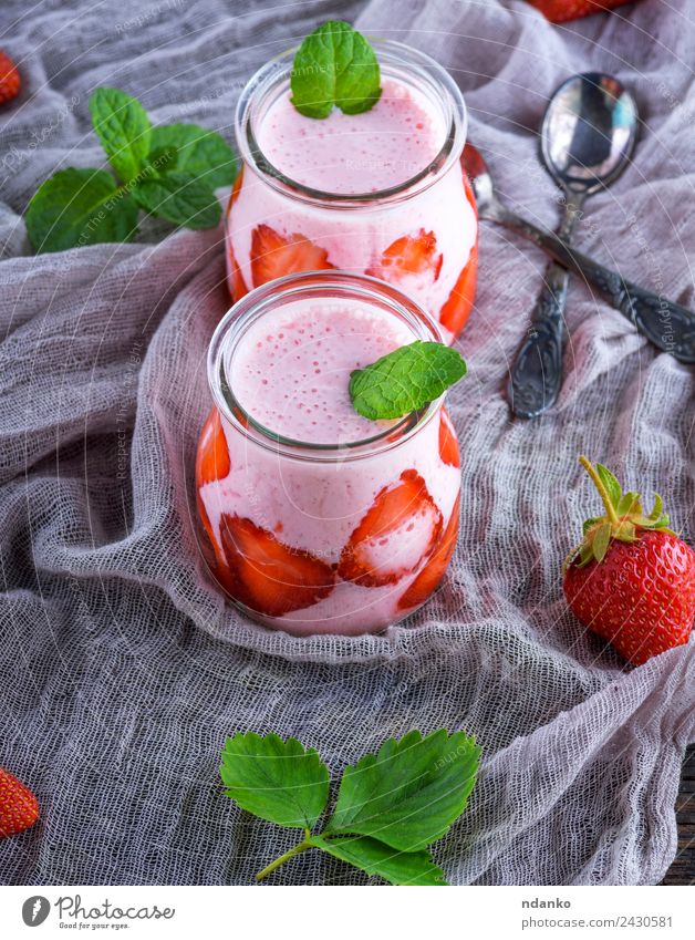 smoothies of fresh strawberries Yoghurt Dairy Products Fruit Dessert Breakfast Diet Beverage Juice Glass Spoon Summer Table Wood Fresh Juicy Green Red Milkshake