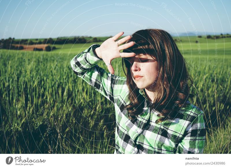 Young woman covering her face from sun in a green field Lifestyle Style Healthy Wellness Senses Relaxation Summer Sun Agriculture Forestry Human being Feminine