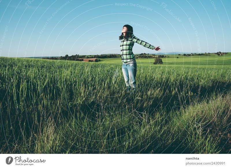 Young woman enjoying the day in a field of green crops Lifestyle Style Joy Healthy Wellness Harmonious Well-being Senses Vacation & Travel Adventure