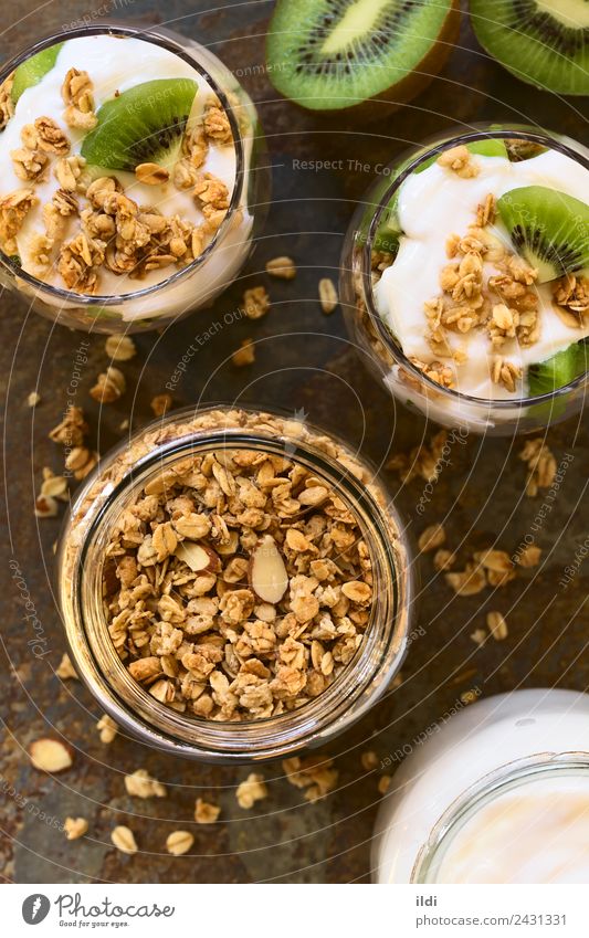 Crunchy Granola and Parfait Yoghurt Fruit Dessert Breakfast Fresh food Cereal crispy oat oatmeal flakes Almond sweet Snack parfait kiwi healthy Meal glass jar