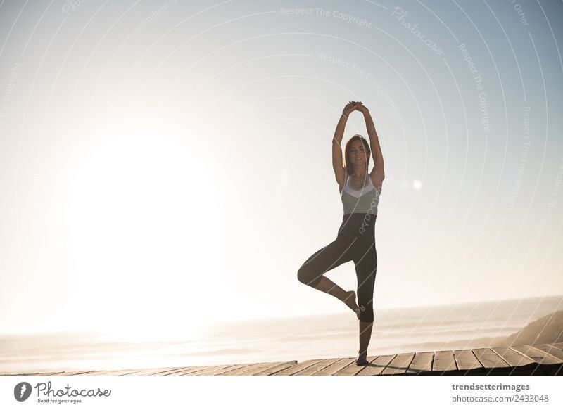 Fit woman enjoying sunset on the beach Lifestyle Body Wellness Relaxation Calm Meditation Freedom Sun Beach Ocean Sports Yoga Woman Adults Nature Sky Fitness