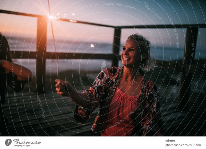 happy young adult woman holding sparkler by sunset at beach Lifestyle Joy Happy Beautiful Vacation & Travel Summer Sun Beach Ocean Woman Adults Nature Sky Coast