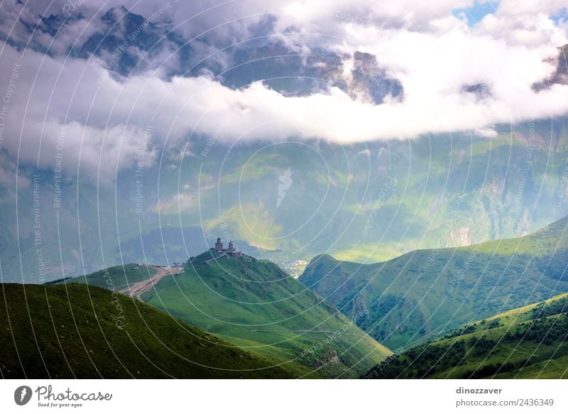 Trinity church in Kazbegi, Georgia Vacation & Travel Summer Mountain Culture Nature Landscape Sky Clouds Grass Hill Church Old Historic Green Religion and faith