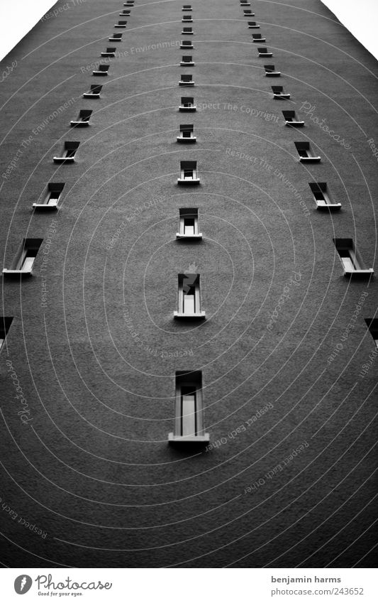 high (out) house Town High-rise Architecture Wall (barrier) Wall (building) Facade Window Sharp-edged Large Hideous Tall Long Gloomy Gray Black & white photo