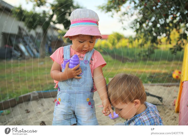 children playing the sand, one giving directions to the other Parenting Education Kindergarten Human being Child Toddler Parents Adults Brothers and sisters