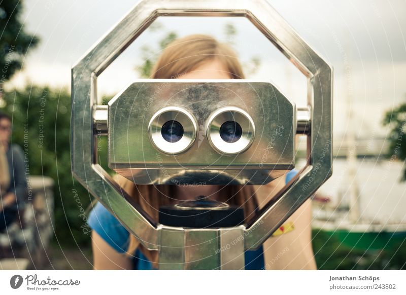 young woman looks through binoculars Vacation & Travel Tourism Trip Far-off places Freedom Sightseeing Human being Eyes 1 Looking Surveillance Vantage point